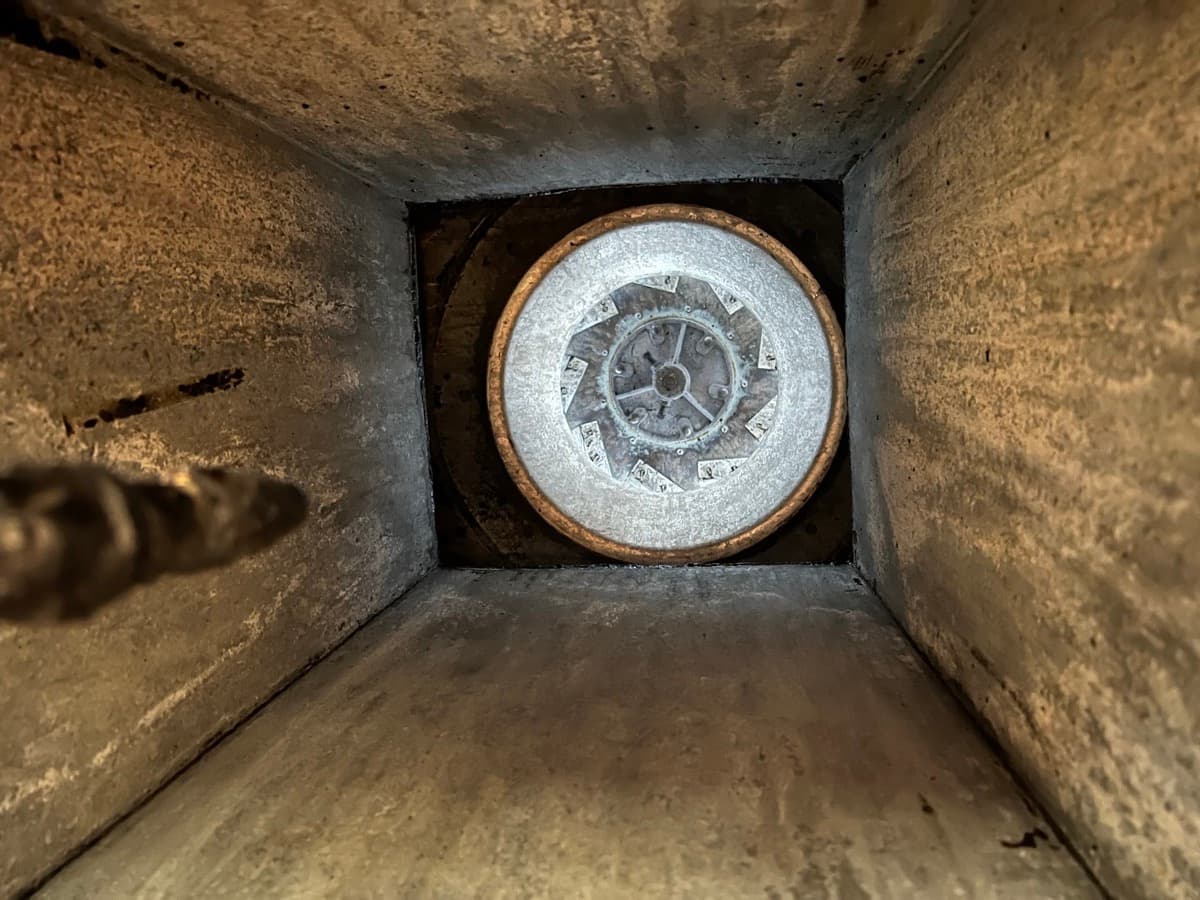 Looking down a cleaned kitchen exhaust duct at the fan wheel