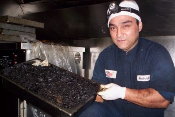 Man showing how dirty the hood was before kitchen exhaust cleaning in San Diego