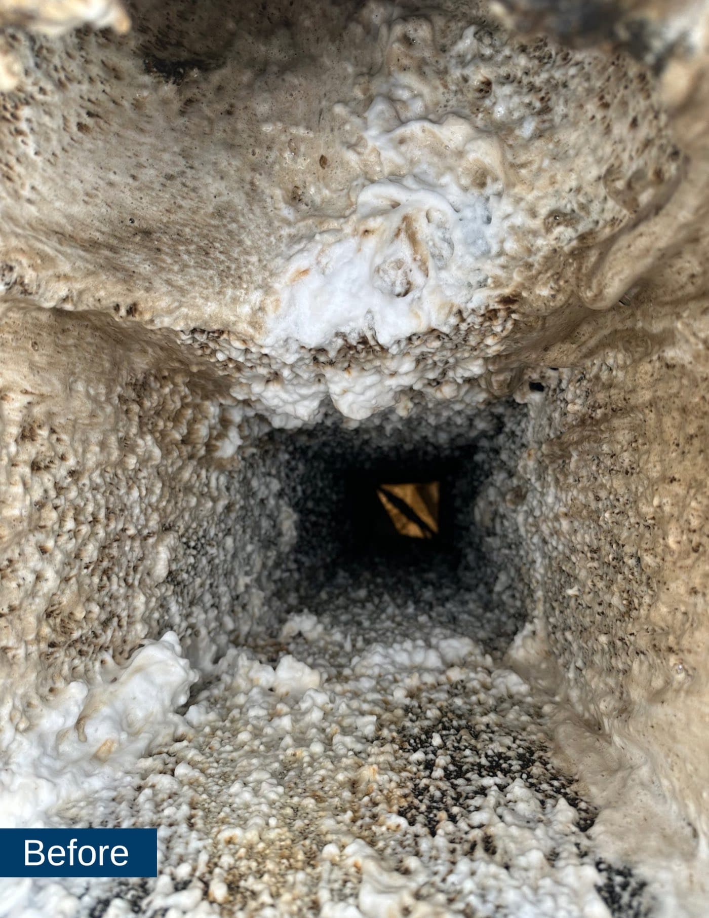 Before: a grease duct interior caked in heavy grease buildup